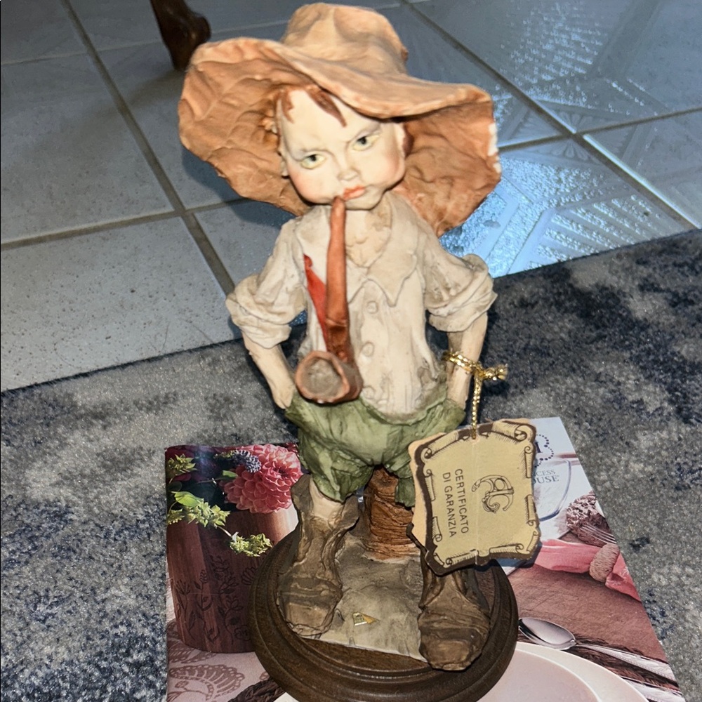 Whimsical Figurine with Brown Hat and Green Pants